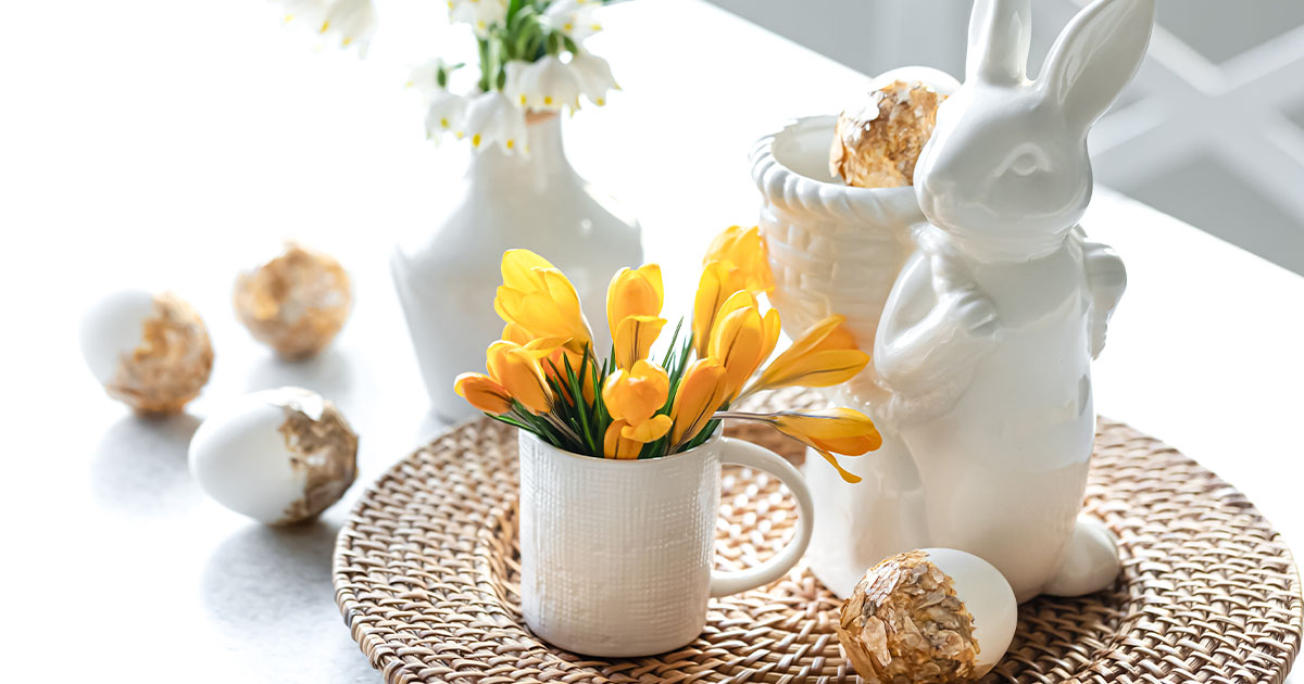 Spring, Easter table place setting with yellow tulips, Easter eggs, and Easter bunny.